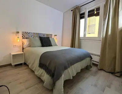 a bedroom with a large bed and a window at Habitación Sant Jeroni en Casa Camí de les Aigües Monistrol de Montserrat in Monistrol
