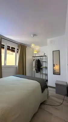 a bedroom with a large white bed and a window at Habitación Sant Jeroni en Casa Camí de les Aigües Monistrol de Montserrat in Monistrol