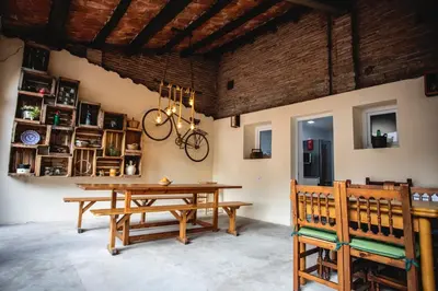 a living room with a couch and a chair and stairs at Habitación Sant Jeroni en Casa Camí de les Aigües Monistrol de Montserrat in Monistrol