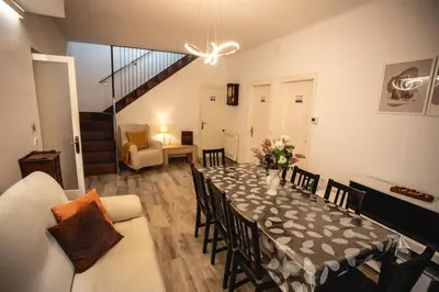 a dining room with a table with a vase of flowers on it at Habitación Montgros en Casa Camí de les Aigües Monistrol de Montserrat in Monistrol