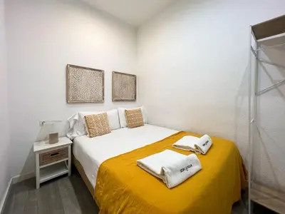 a small bedroom with a bed with towels on it at Stay U-nique Apartments Rossello in Barcelona