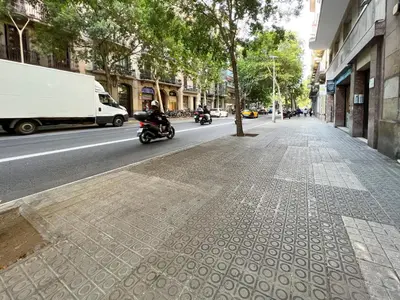 two people riding motorcycles down a city street at Stay U-nique Apartments Rossello in Barcelona