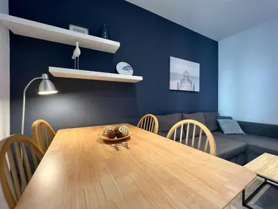 a dining room with a wooden table and a couch at Stay U-nique Apartments Rossello in Barcelona