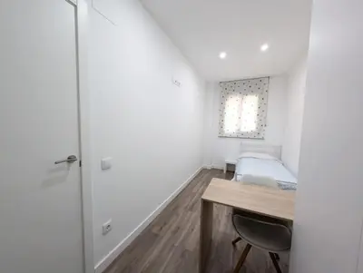 a small bedroom with a desk and a bed at New flat in the centre, 10 min from BCN Airport in Cornellà de Llobregat
