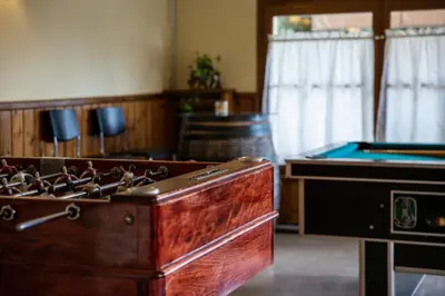 a room with a wooden chest and a pool table at Hostal Montserrat in Montseny