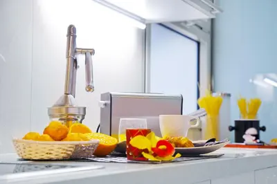 a kitchen counter with a bunch of oranges and drinks at Victoria City Center Barcelona in Barcelona