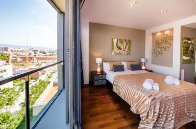 a bedroom with a bed and a balcony at Victoria Diagonal Mar Barcelona in Barcelona