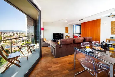 a living room with a couch and a table at Victoria Diagonal Mar Barcelona in Barcelona
