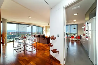 a kitchen and living room with a table and chairs at Victoria Diagonal Mar Barcelona in Barcelona