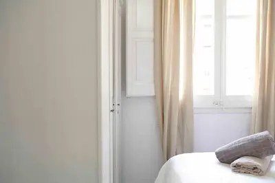 a bedroom with a bed with two pillows and a window at SAGRADA FAMILIA SUN Nos preocupa su seguridad in Barcelona