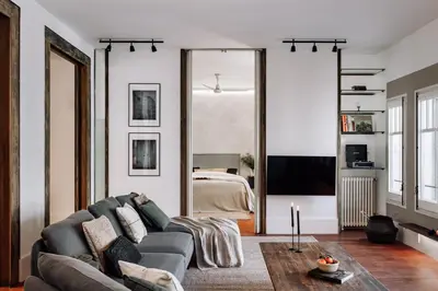 a white bedroom with a large bed and white walls at Zuheros - 2 bedrooms in Eixample Dreta in Barcelona
