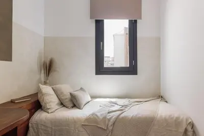 a bedroom with a bed and a window in it at Vietri - 2 bedrooms and terrace in Sant Antoni in Barcelona
