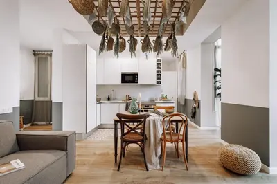 a dining room with a table and chairs and a brick wall at Aroche - 2 bedrooms in Sant Antoni in Barcelona