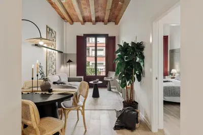 a living room with a table and chairs and a couch at Castell - 2 bedrooms and balcony in Sant Antoni in Barcelona
