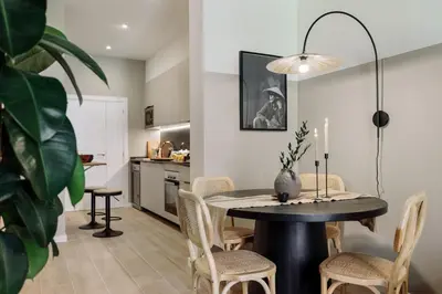 a kitchen with a refrigerator and a table and chairs at Castell - 2 bedrooms and balcony in Sant Antoni in Barcelona
