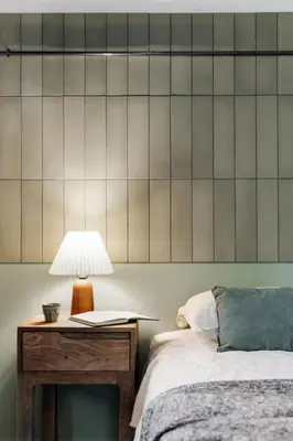 a bedroom with a bed with white sheets and green pillows at Castell - 2 bedrooms and balcony in Sant Antoni in Barcelona
