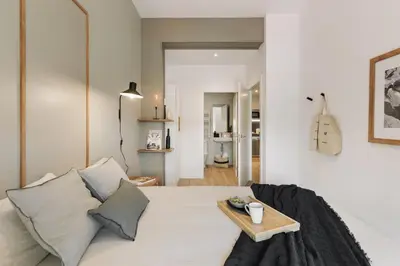 a white bedroom with a bed with a tray on it at Canyelles - 2 bedrooms in Sant Antoni in Barcelona
