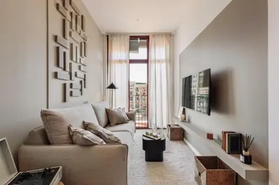 a living room with a couch and a large window at Miravet - 2 bedrooms in Sant Antoni in Barcelona