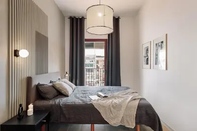 a bedroom with a bed and a table with a night stand at Miravet - 2 bedrooms in Sant Antoni in Barcelona