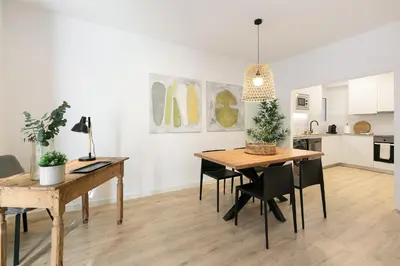 a kitchen and dining room with a table and chairs at Cathedral Ramblas Apartment in Barcelona