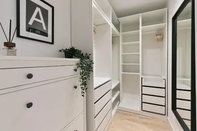 a walk in closet with white cabinets and a mirror at Cathedral Ramblas Apartment in Barcelona