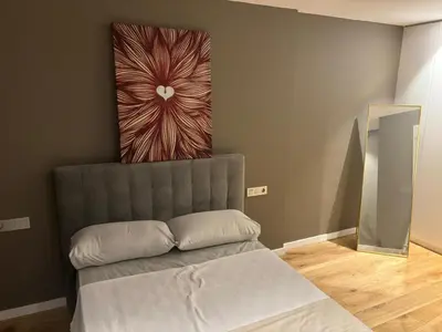 a couch in a room with a painting on the wall at esplugues de llobregat in Barcelona
