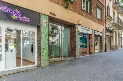 a row of store fronts on a city street at Canela Homes BARCELONA SANT PAU in Barcelona