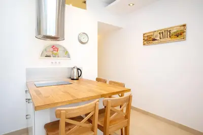 a dining room with a wooden table and chairs at Gracia Travesera 2 Bedrooms Renovated Apartment in Barcelona