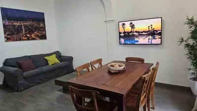 a living room with a wooden table and a couch at Romantic 19th century apartment in Barcelona