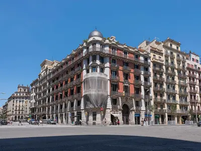 a building with a glass dome on the front of it at Habitas Stay Barcelona in Barcelona