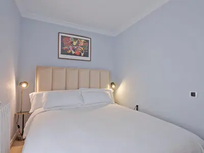 a bedroom with a large bed with white sheets at Habitas Stay Barcelona in Barcelona