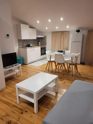 a kitchen and living room with a table and chairs at Cal 2 de Maig in Vilafranca del Penedès