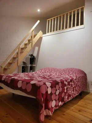 a bed in a room with a staircase at Cal 2 de Maig in Vilafranca del Penedès