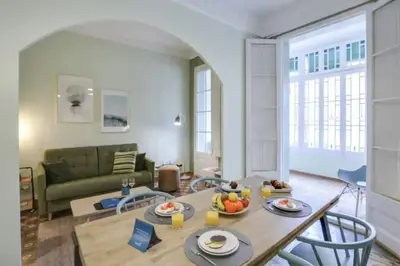 a living room with a table and a couch at Passeig Sant Joan in Barcelona