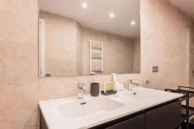 a bathroom with a white sink and a mirror at Sweett - Nova Icaria Beach in Barcelona