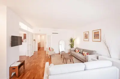a white living room with a couch and a table at Sweett - Nova Icaria Beach in Barcelona