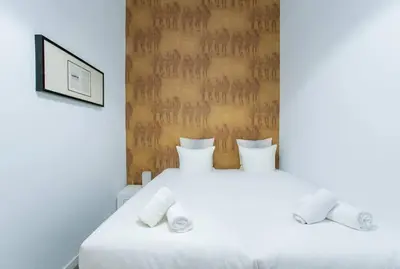a bedroom with two beds with white sheets at Canela Homes BARCELONA VALÈNCIA in Barcelona