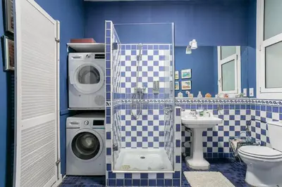 a bathroom with a washing machine and a washer at Canela Homes BARCELONA CLASSIC in Barcelona