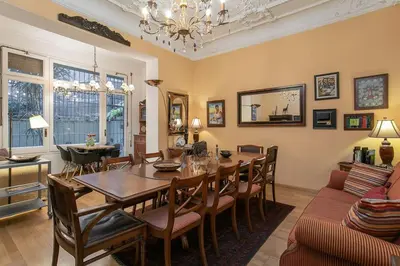 a dining room with a wooden table and chairs at Canela Homes BARCELONA CLASSIC in Barcelona