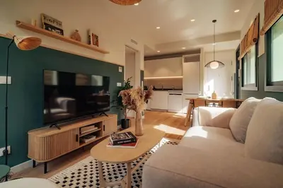 a living room with a couch and a television at Casa Morera in Barcelona