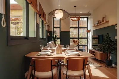 a dining room with a wooden table and chairs at Casa Morera in Barcelona