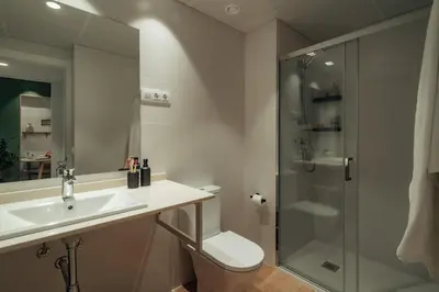 a bathroom with a toilet and a sink and a shower at Casa Morera in Barcelona