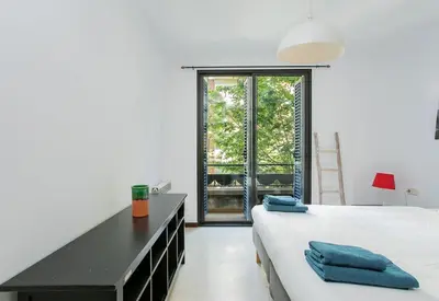 a bedroom with a bed and a desk and a window at Canela Homes BARCELONA MONUMENTAL in Barcelona