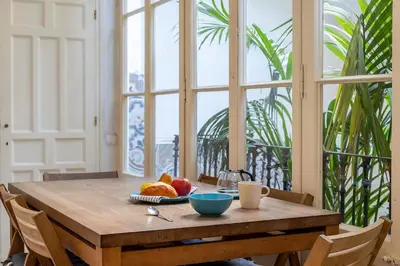 a wooden table with a bowl of fruit on it at Canela Homes BARCELONA PATIO in Barcelona