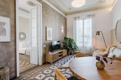 a living room with a table and a bed at Casa Ribera in Barcelona