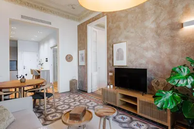 a living room with a couch and a tv at Casa Ribera in Barcelona