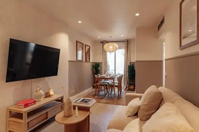 a living room with a couch and a flat screen tv at Casa Tamarita in Barcelona