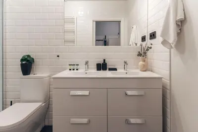 a white bathroom with a sink and a toilet at Casa Atlas in Barcelona
