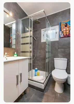 a bathroom with a shower and a toilet and a sink at Apartamento BB in Hospitalet de Llobregat