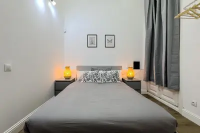 a bedroom with a large bed with two lamps at Apartamento Rambla Cataluña 35 in Barcelona